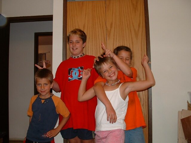 The four Forget kids clowning around at home in Canada before the move to Mexico