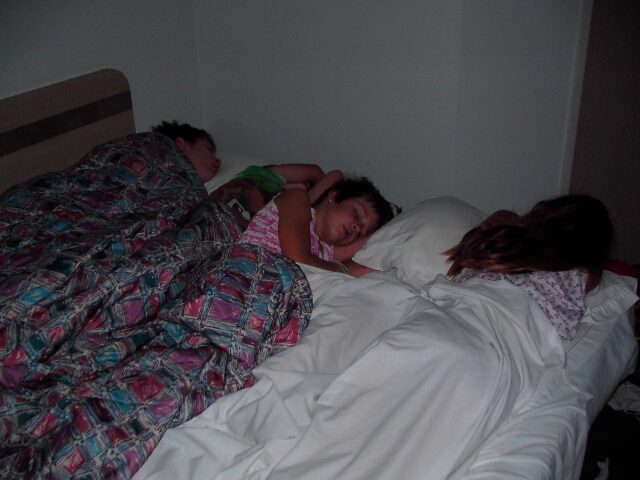 The Forget children piled together asleep on one bed during the drive south to Mexico