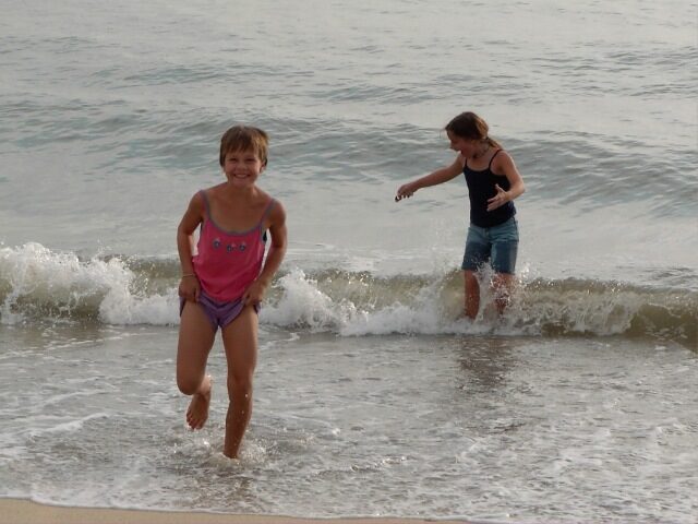 Two of the Forget children playing in the surf during their first days in Bucerias, Mexico